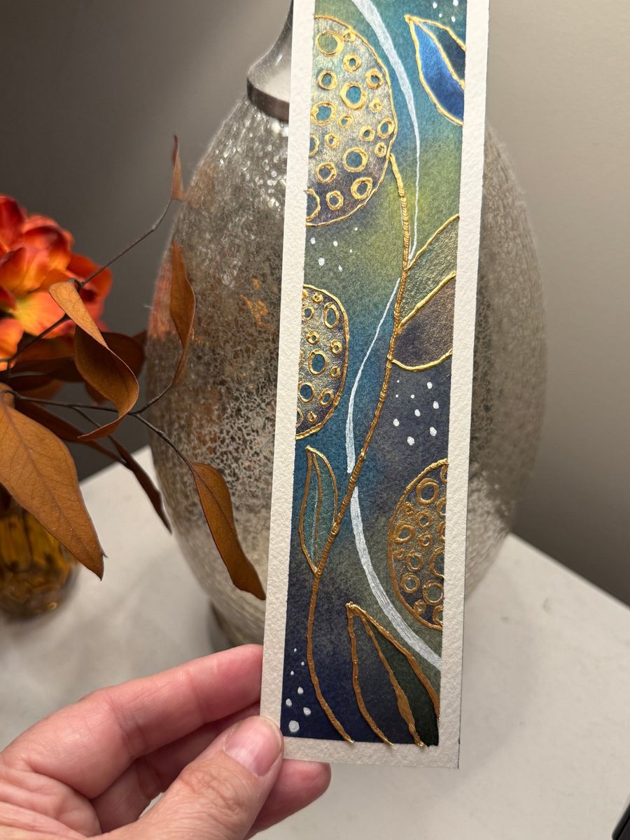 Jen's watercolor bookmark in teal, green and navy with raised gold circles and leaves