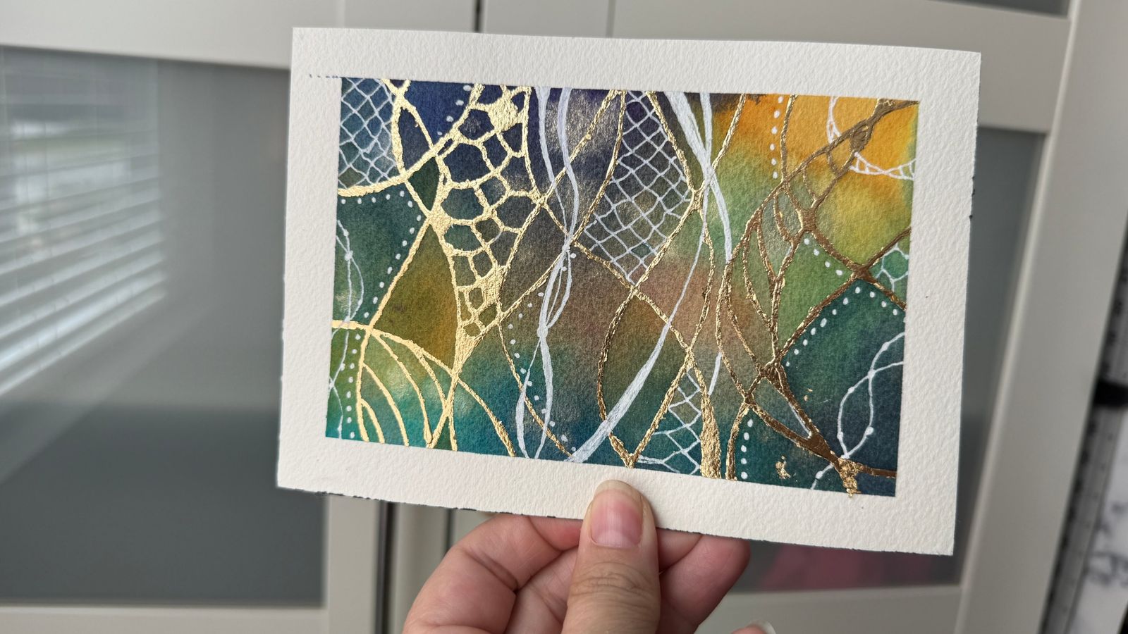 Jen's watercolor in deep blue, green and orange with gold lacework and white netting