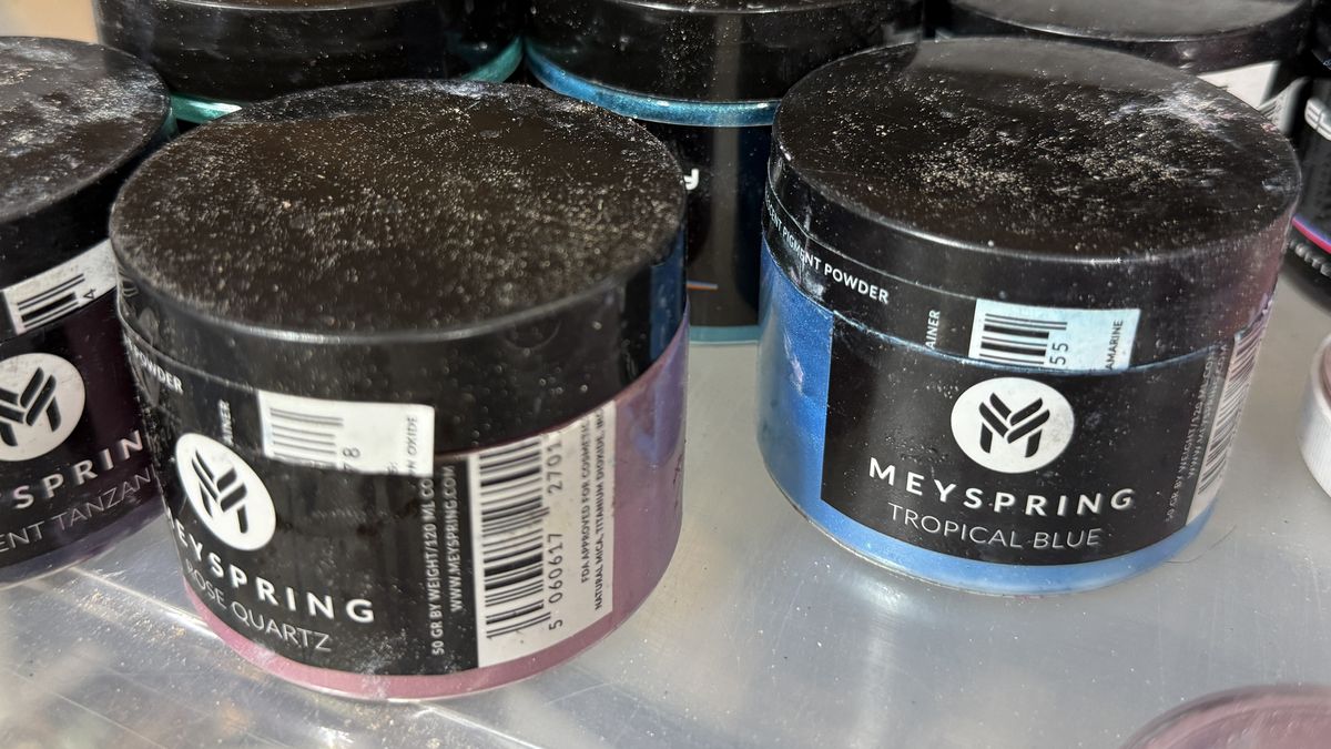 Jen's bin of mica powders, with Eye Candy and MEYSPRING jars including MEYSPRING Tropical Blue and Opulent Tanzanite